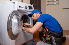 Plumber adjusting water pressure regulator to fix low water pressure in washing machine